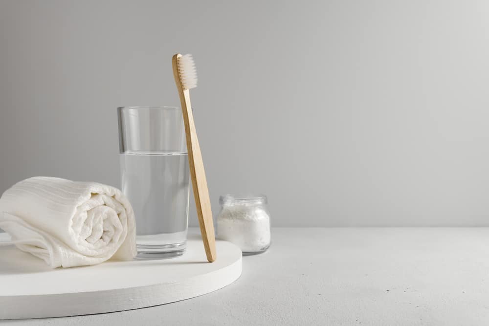 Bamboo,Toothbrush,,Glass,Of,Water,,White,A,Cotton,Towel,And