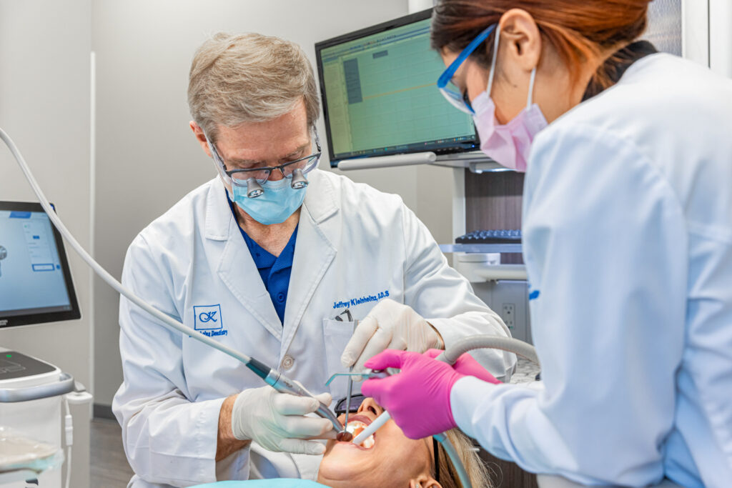 A dentist near Arboretum performs a routine dental cleaning. A dental cleaning every 6 months is recommended to keep your teeth healthy and strong.