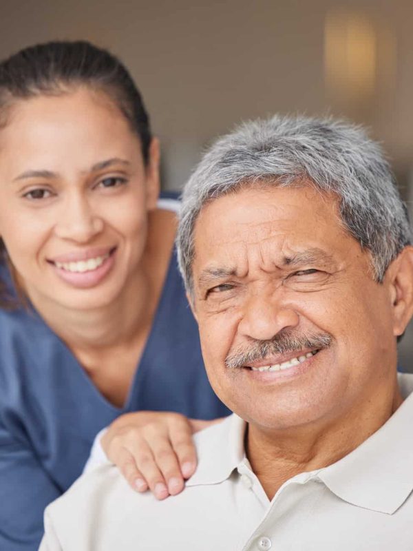 portrait-of-elderly-man-with-a-nurse-bonding-during-a-checkup-at-assisted-living-homecare-smile-.jpg