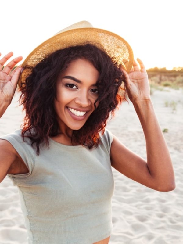 Close,Up,Of,Smiling,Young,African,Girl,In,Summer,Hat